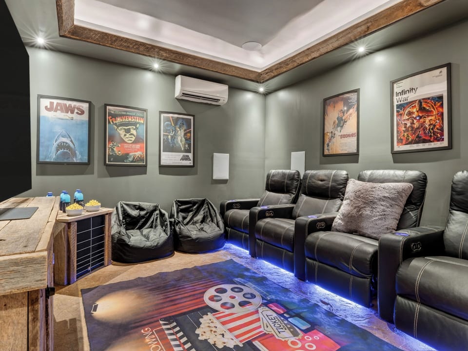 Private theater room with recliner seating for movie nights and group hangouts.