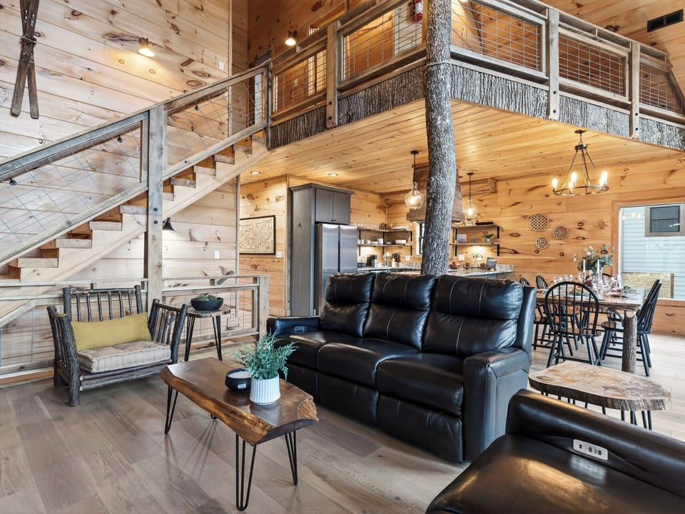Inviting great room with a stone fireplace and comfortable seating for gathering together.