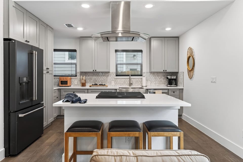 Close-up of the kitchen island with three leather barstools for casual dining.
