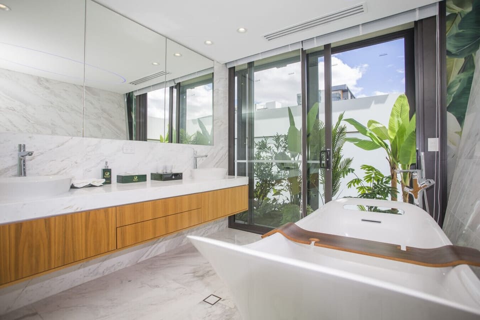 Double vanity and full bath with mood lighting perfect for relaxation.