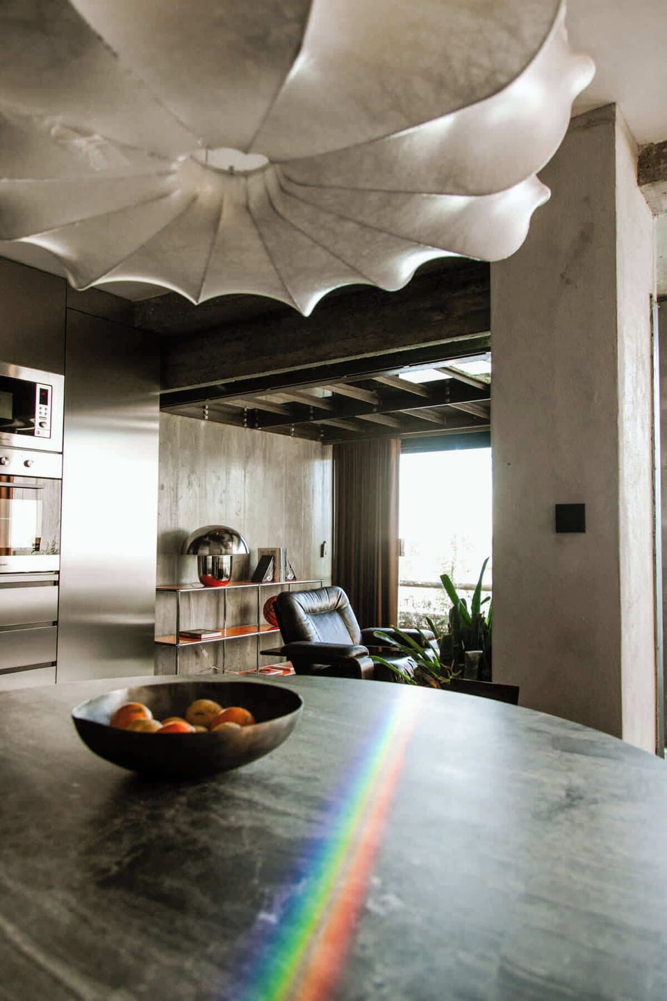 Statement chandelier lighting above the dining table in the open living area.