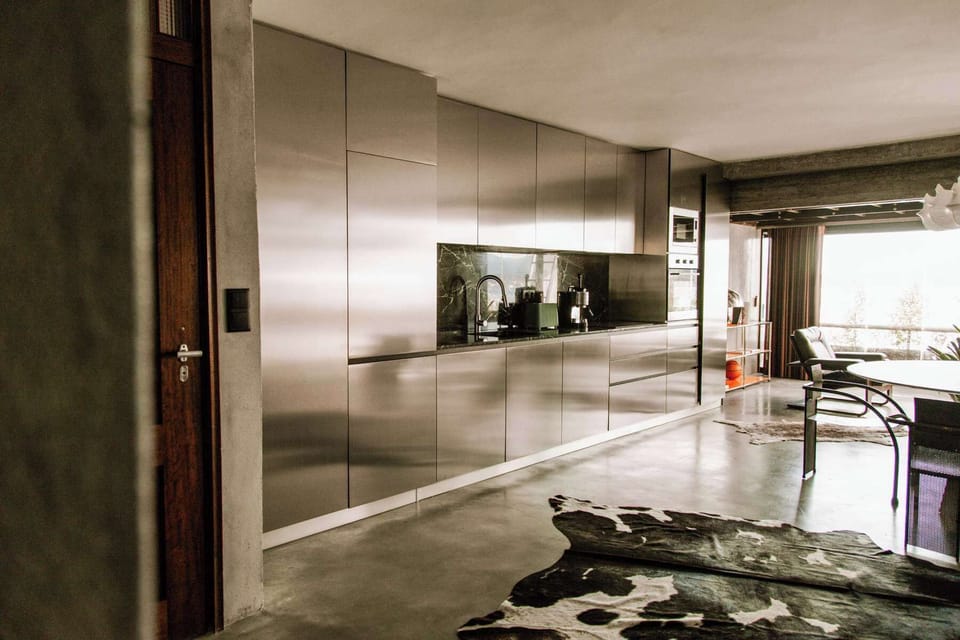Integrated kitchen cabinetry with sleek reflective finishes.