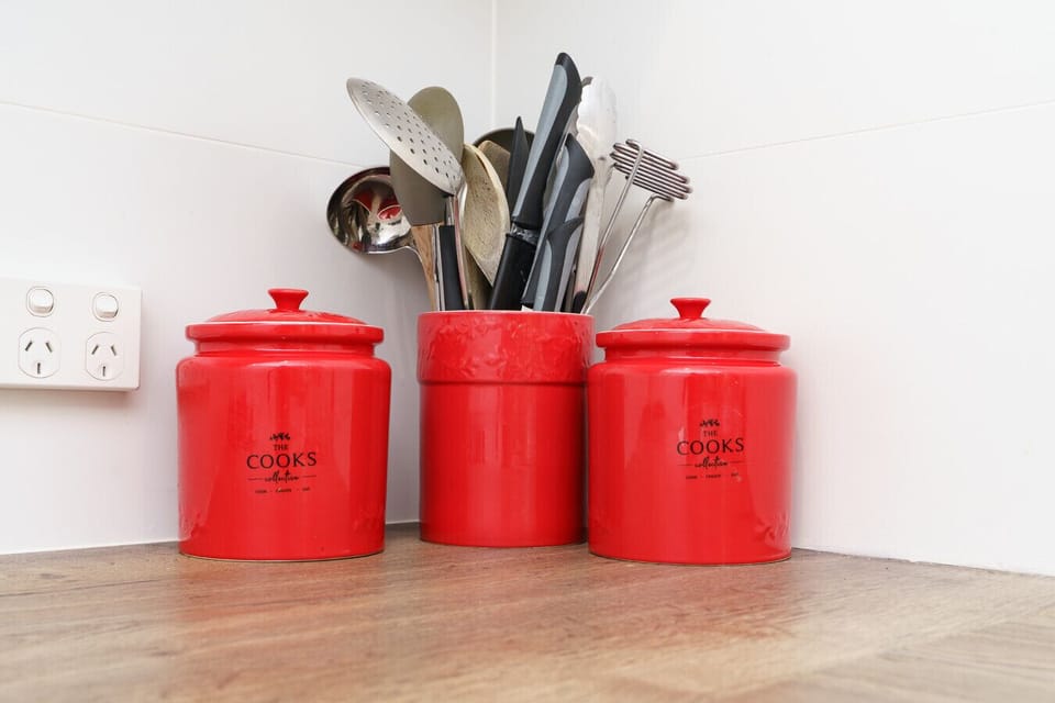 Thoughtful touches in the kitchen, like matching canisters, make it feel homely and organised.