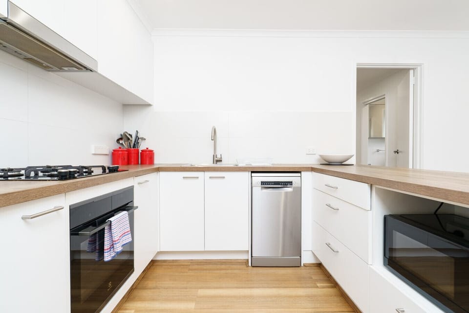 Enjoy the fully equipped kitchen with sleek surfaces and ample space for cooking.