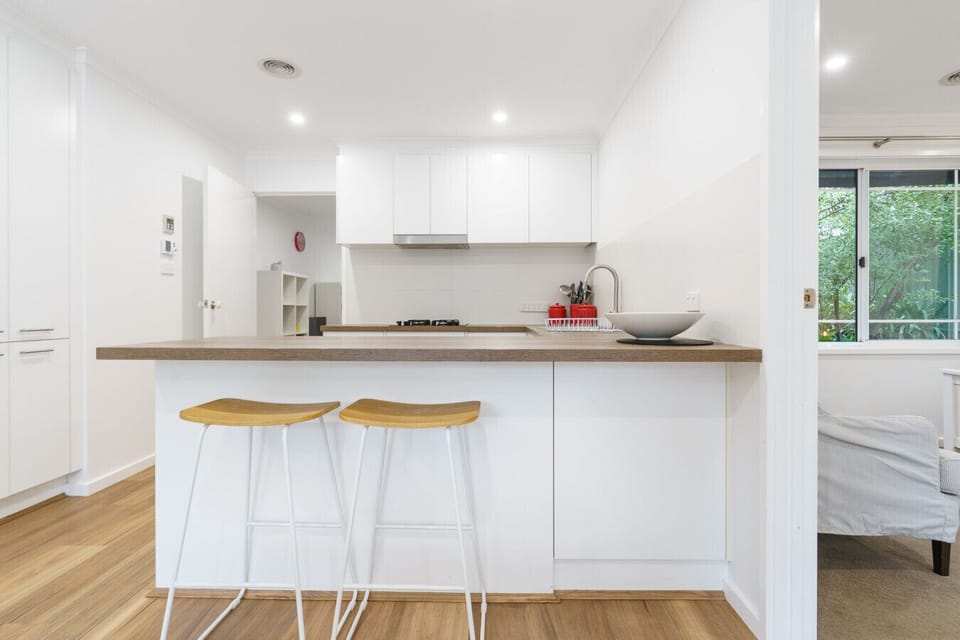 Enjoy the fully equipped kitchen with sleek surfaces and ample space for cooking.