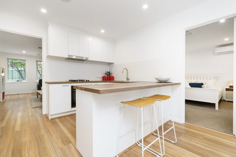 Enjoy the fully equipped kitchen with sleek surfaces and ample space for cooking.