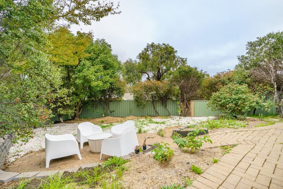 Outdoor seating in a lush garden setting, perfect for morning coffee or evening drinks.