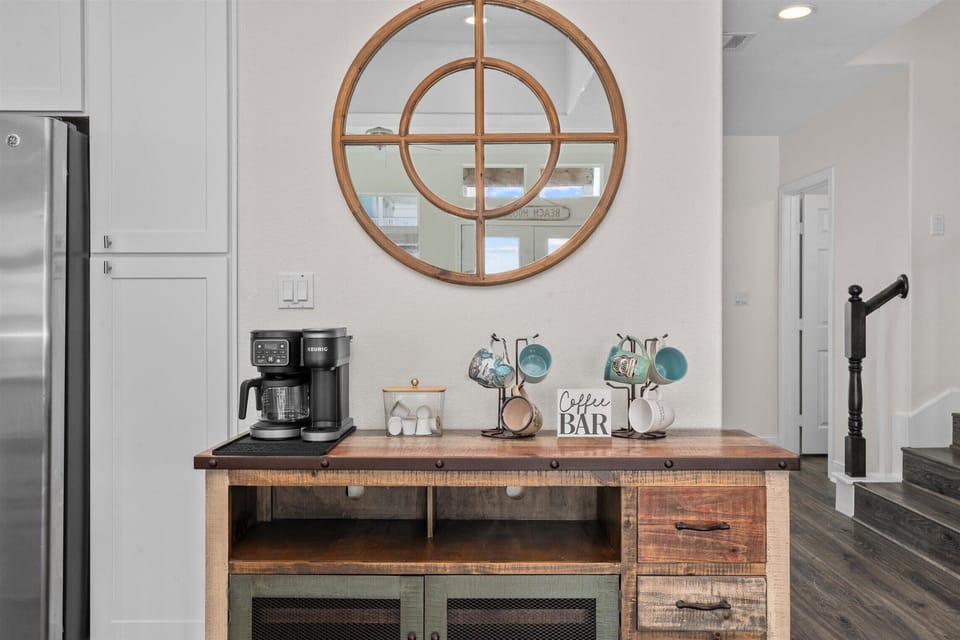 Stylish coffee bar and beverage station with decorative shelving and coastal accents in the Galveston beach rental.
