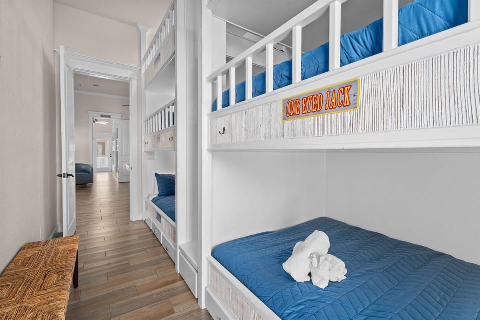 Bunk room with custom built beds and bright coastal decor