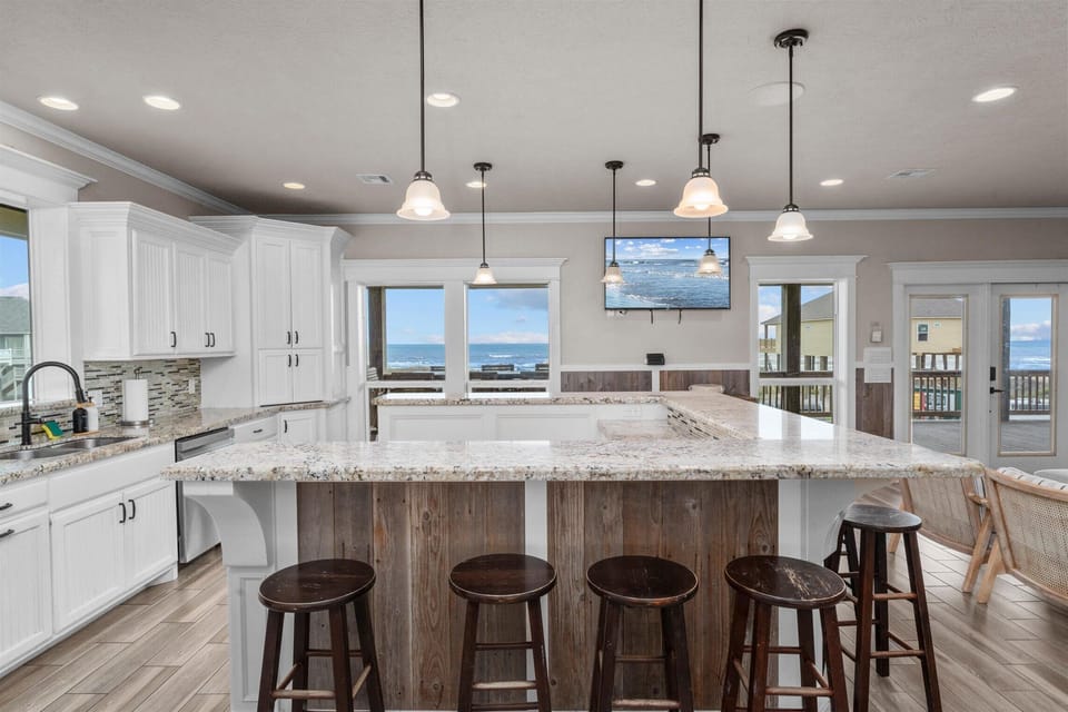 Kitchen with dual islands, pendant lights, and expansive prep space