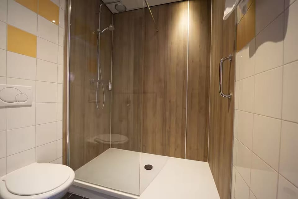 Refresh under a sleek glass shower after a long day.