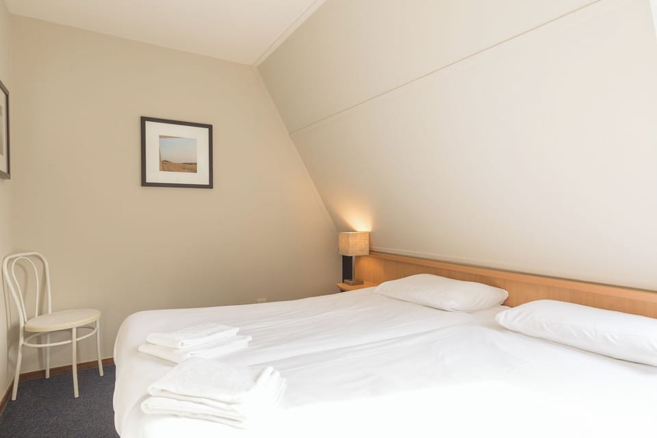 Drift into deep sleep on crisp linens and soft pillows.