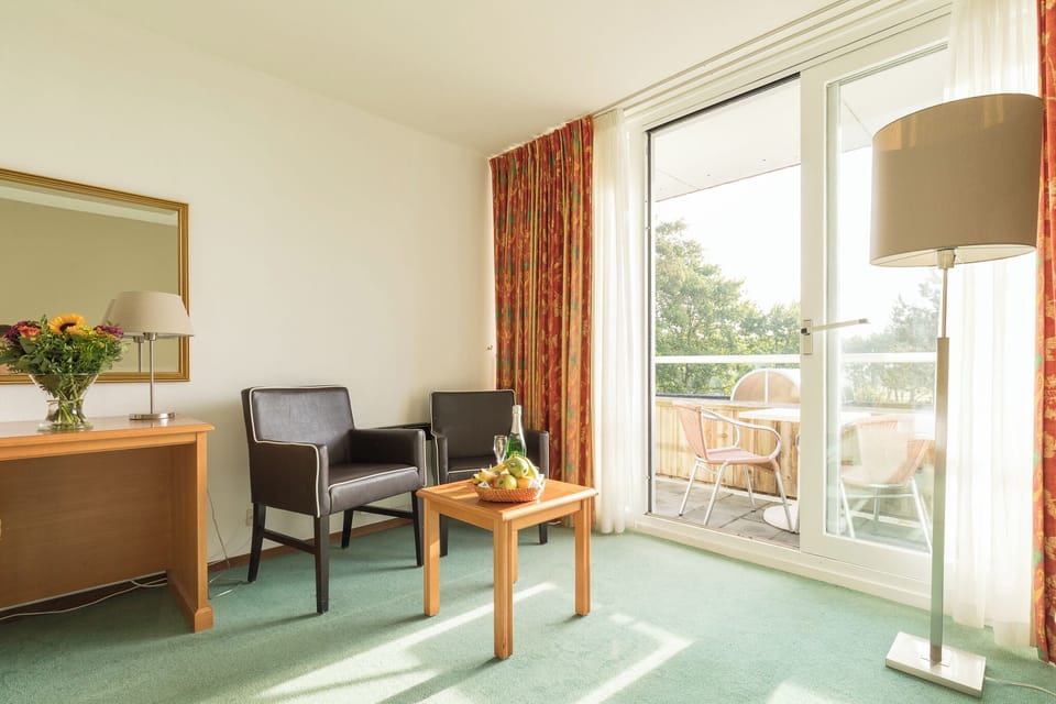 Sip morning coffee as doors open to a private balcony.