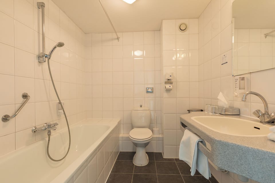 Refresh with a deep soaking tub and spotless tiled finish.