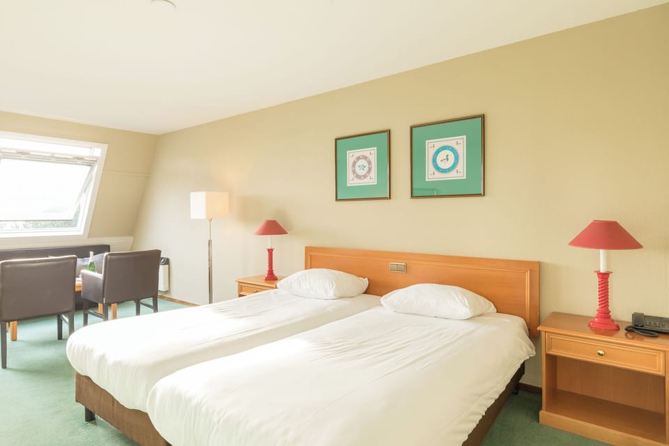 Unwind in crisp linens with warm bedside lighting.