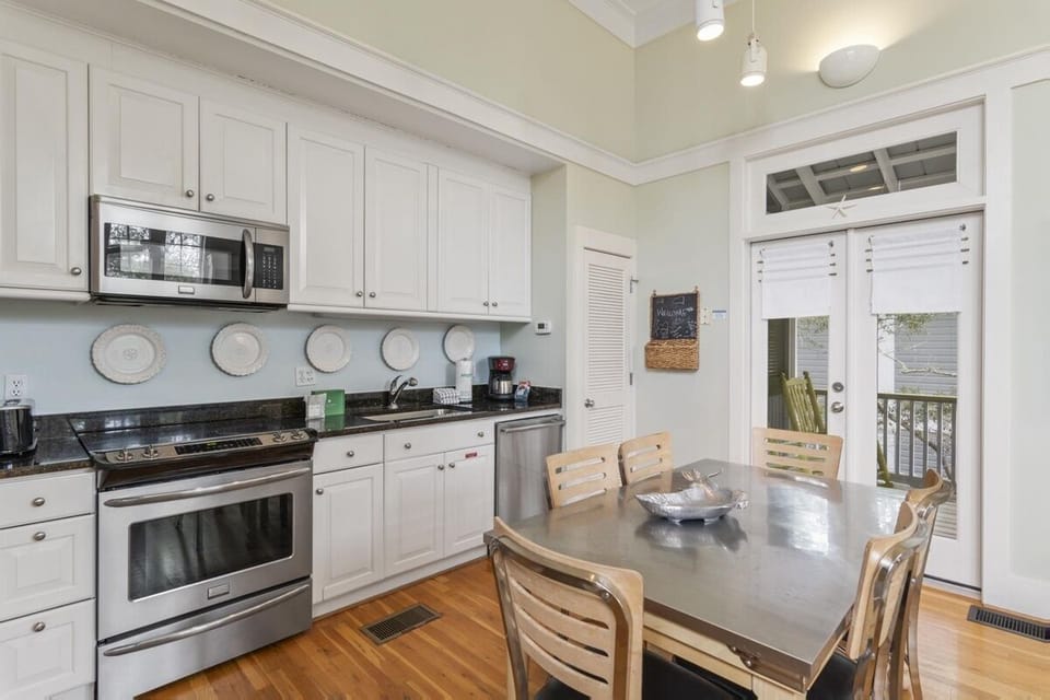 IN-KITCHEN DINING FOR SIX WITH FRENCH DOORS LOOKING TO BALCONY