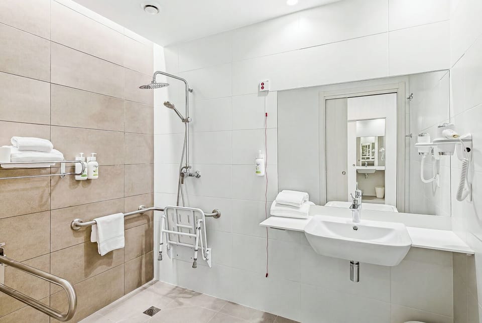 Twin Room | Bathroom | Shower, hair dryer, towels, soap