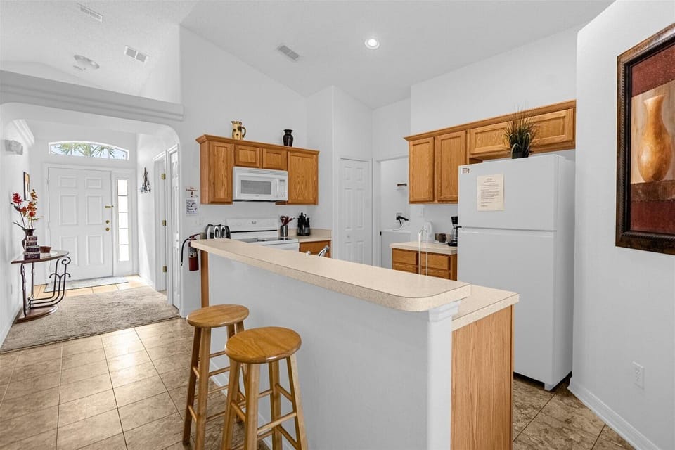 Entry Way View with Kitchen and Breakfast Bar that seats 2 people.
