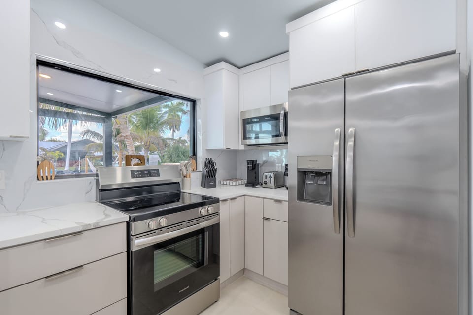 Kitchen with a View of Pool and Canal