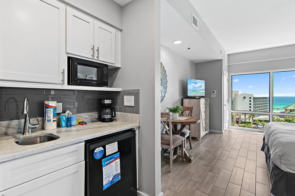 Convenient kitchenette with mini fridge, microwave, coffee maker, and sink