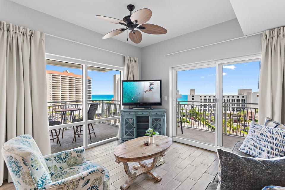 Relax in the spacious living area with balcony access and coastal scenery