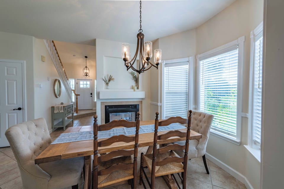 Gather around your elegant dining table where warm chandelier light creates the perfect ambiance for memorable meals with loved ones.