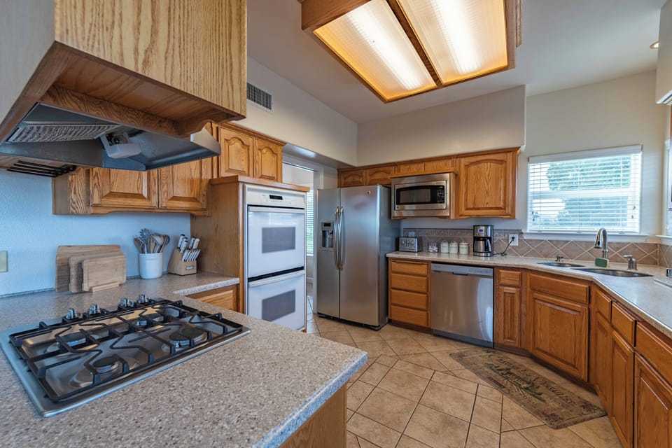 Your fully equipped kitchen features granite counters, stainless appliances, and warm wood cabinets for memorable meal preparation.