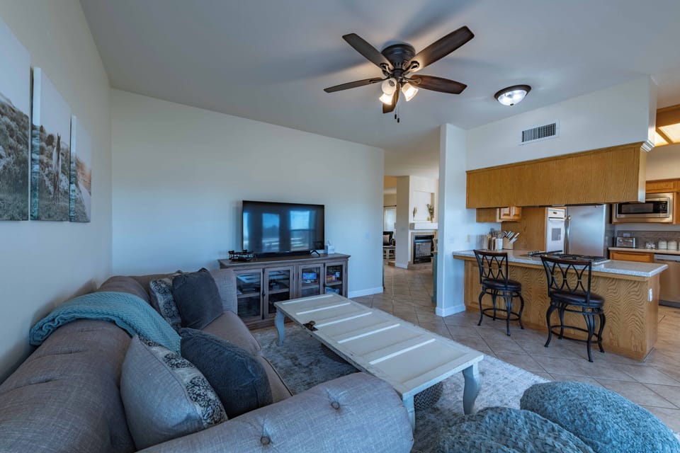 Settle into your spacious living room with plush seating and modern entertainment, seamlessly connected to your fully-equipped kitchen for easy vacation dining.