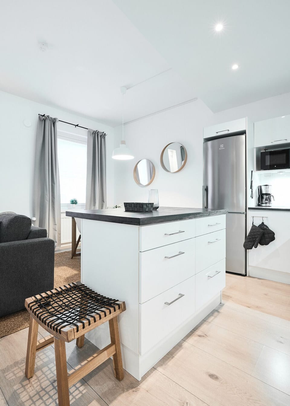 The versatile kitchen island offers extra counter space for cooking or doubles as a convenient spot for a quick breakfast.