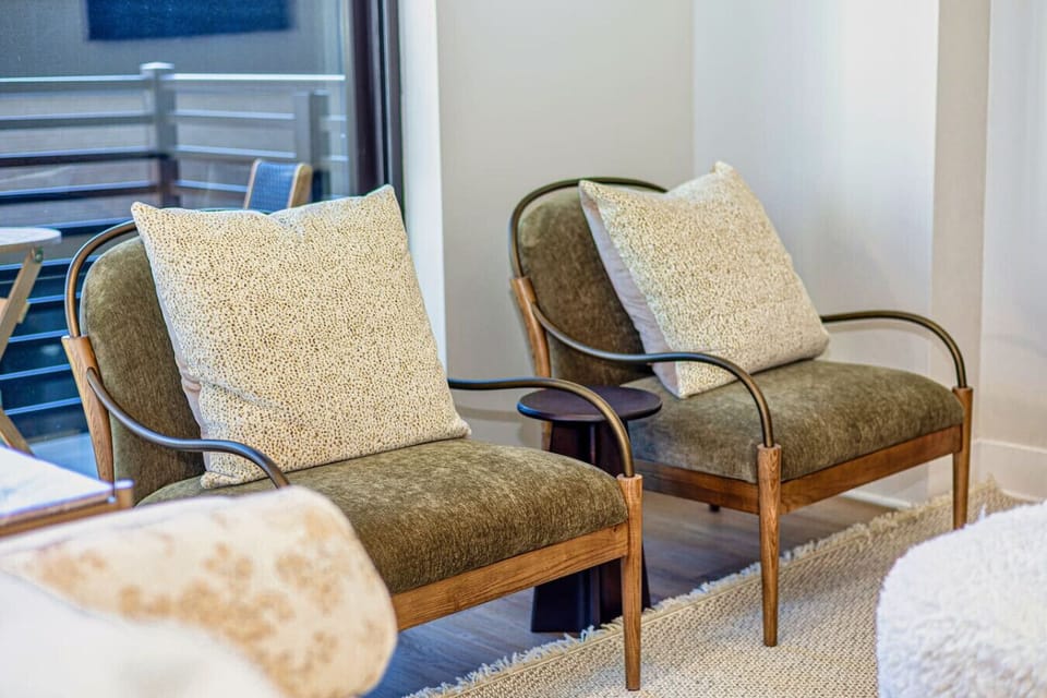 Sitting Room: Stylish seating with plush pillows and a perfect view for relaxation and fun!