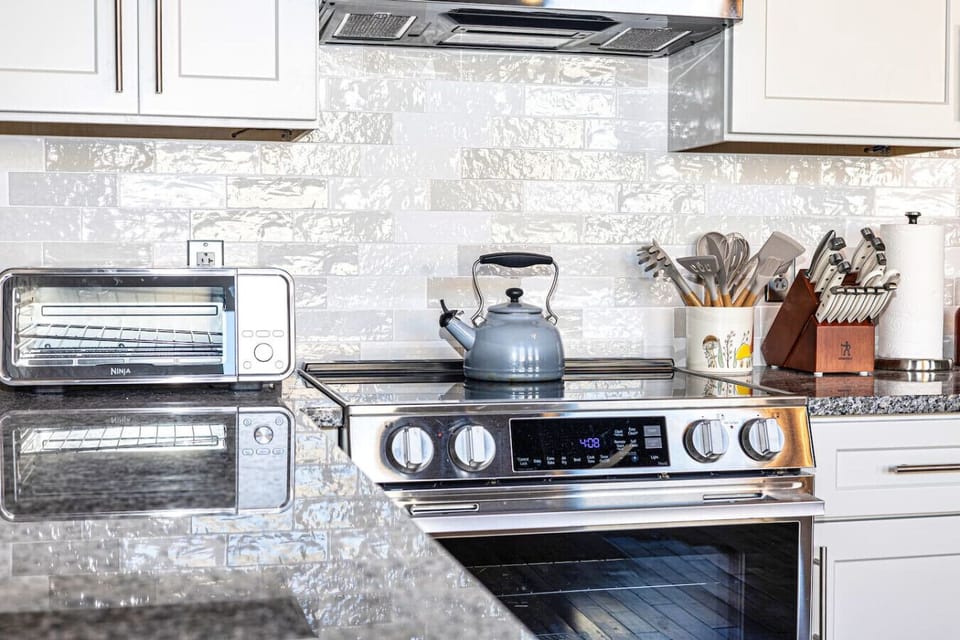 Kitchen: Modern appliances and sleek finishes make meal prep a delight in this stylish space!