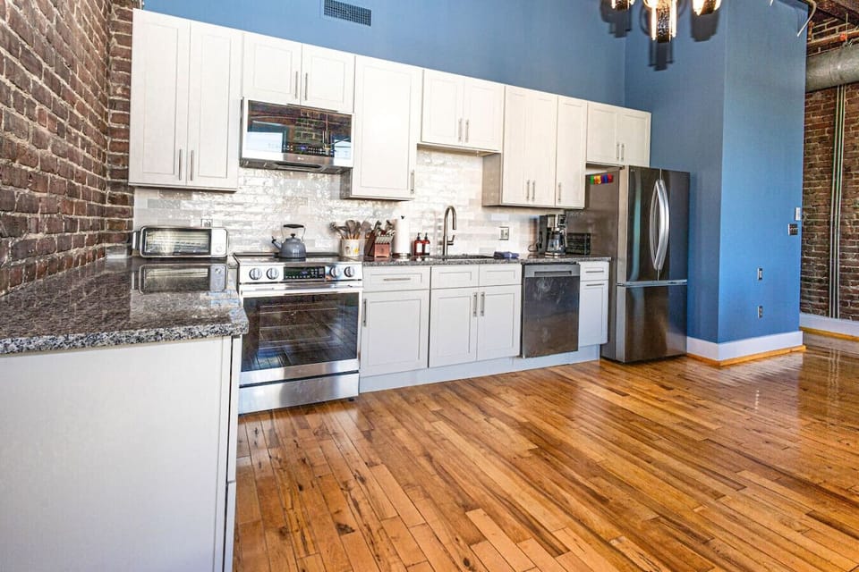 Kitchen: Sleek design with modern appliances and a stylish brick wall—whip up delightful meals!