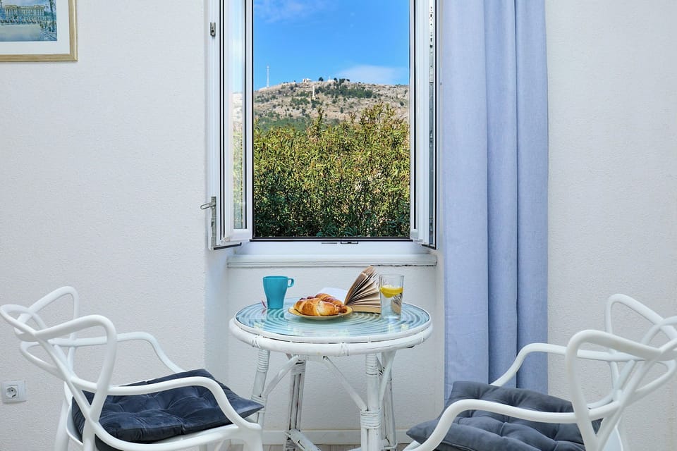 Start your day with breakfast and coffee at this charming bistro set, perfectly positioned to capture stunning views of the lush hillside.