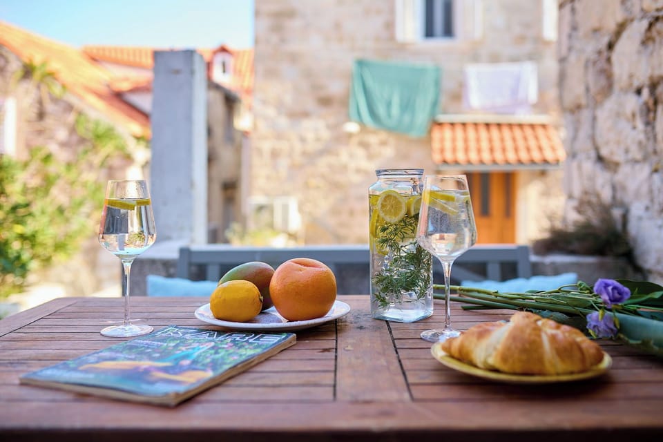 Enjoy a quiet moment on your private terrace, a charming spot to savor breakfast or a refreshing drink amidst the historic stone buildings.