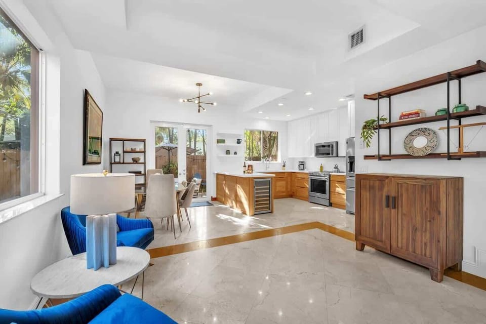 “Fully equipped kitchen with a dining table, extra seating, and just a few steps to the backyard.
