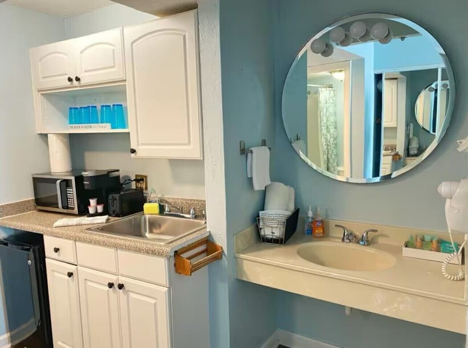 A bathroom with hair dryer, towels and all the basic items!