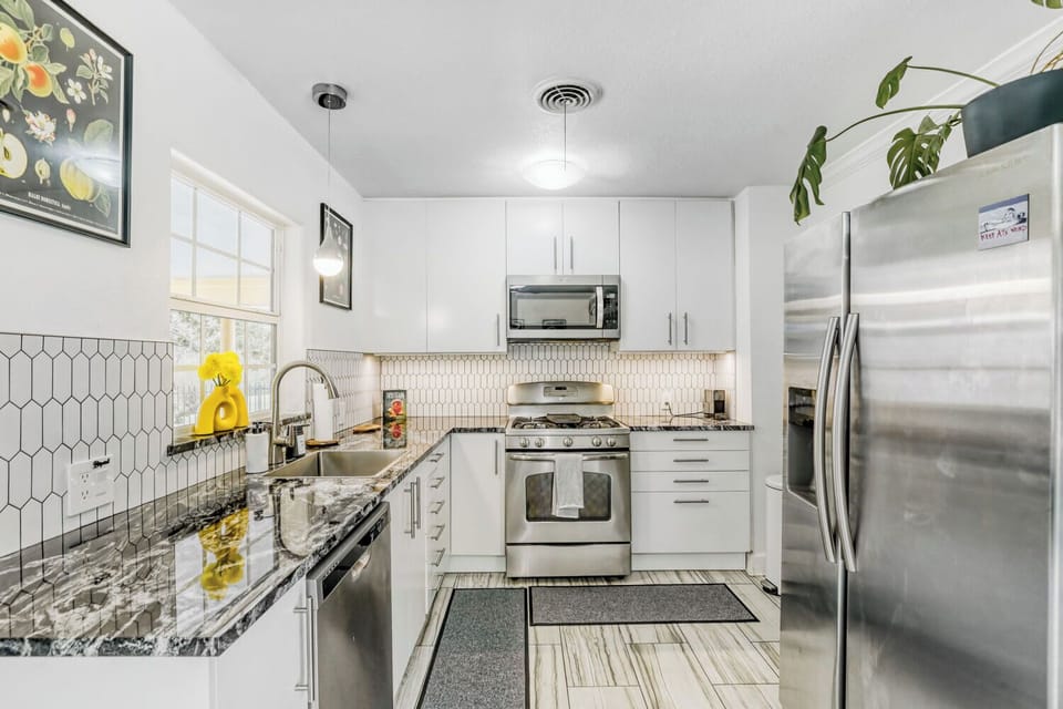 Fully equipped kitchen with stainless steel appliances and plenty of space to cook and gather