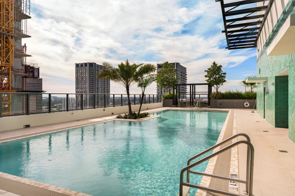 Resort-style rooftop pool with skyline views.