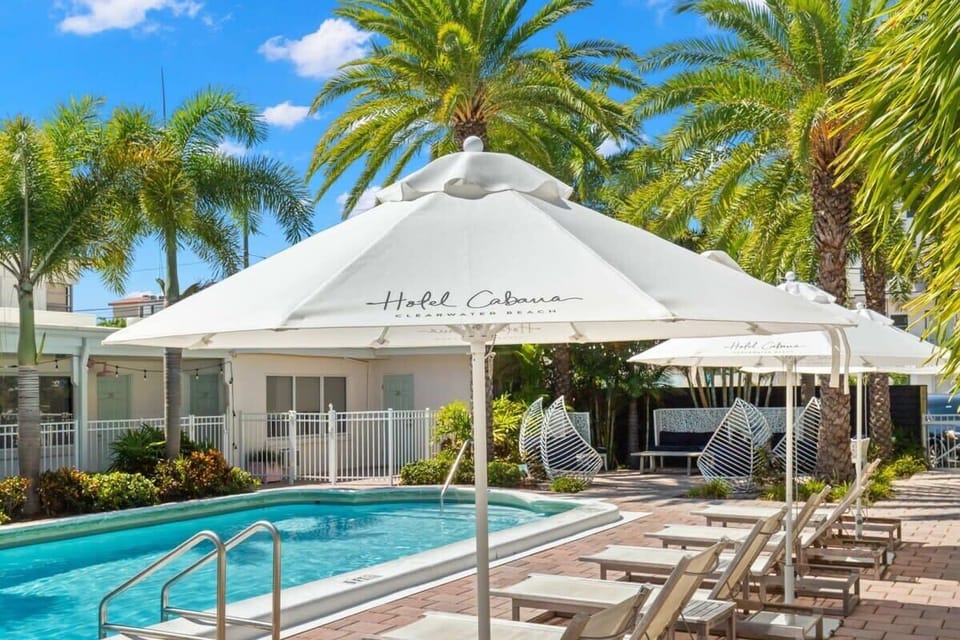 Lounge area with umbrellas by pool