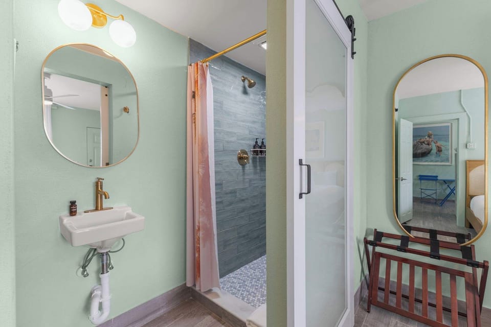 Freshen up in this charming bathroom, featuring a walk-in shower, stylish coastal-inspired finishes, and thoughtful details throughout.
