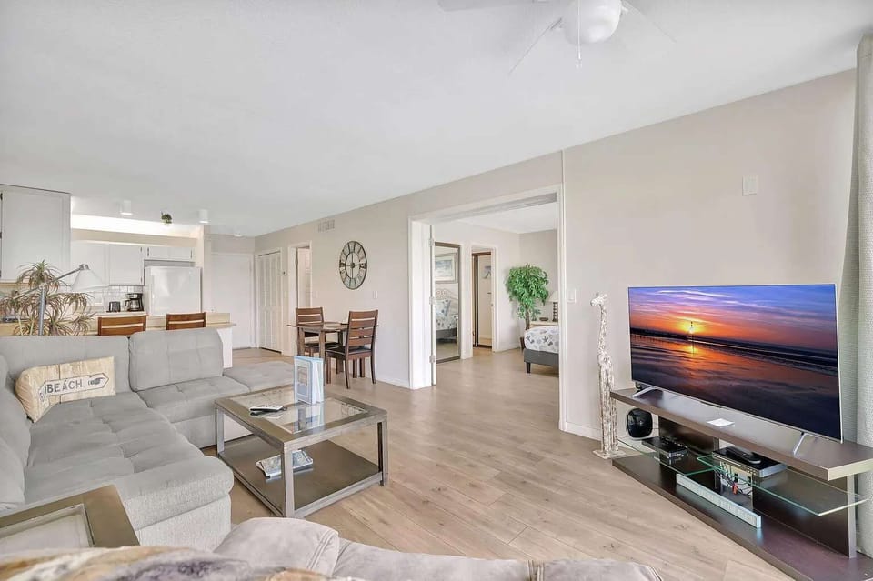 Enjoy downtime in this spacious open-concept living room featuring a Smart TV and plenty of space to relax and gather together.