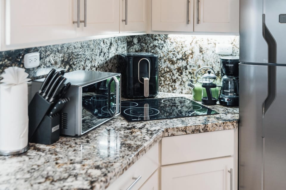 A thoughtfully designed kitchenette offers everything you need for light meals, morning coffee, and easy beach-day snacks.