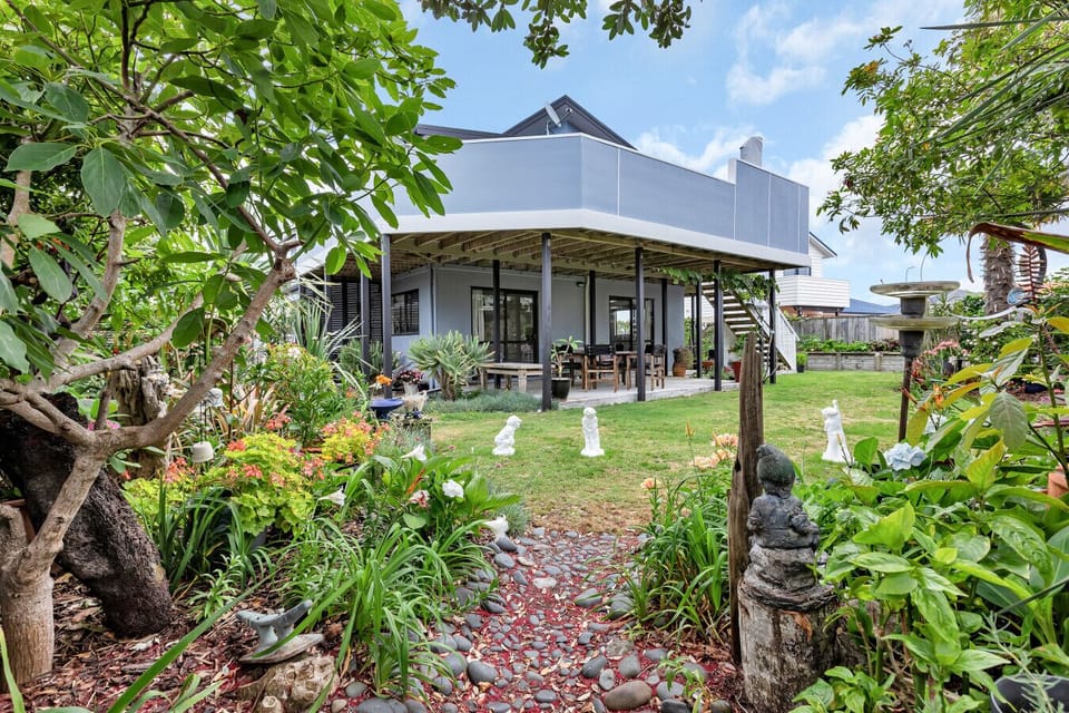 Private outdoor area with shaded deck, dining table, and barbecue