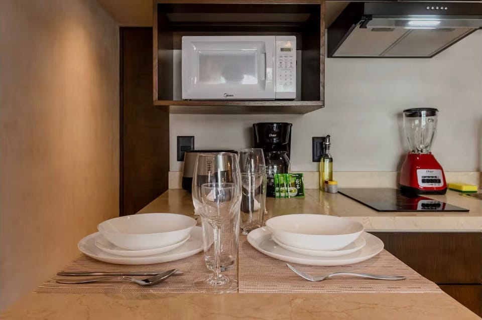 Deluxe Condo, Balcony, Pool View | Private kitchen | Full-size fridge, microwave, dishwasher, cookware/dishes/utensils