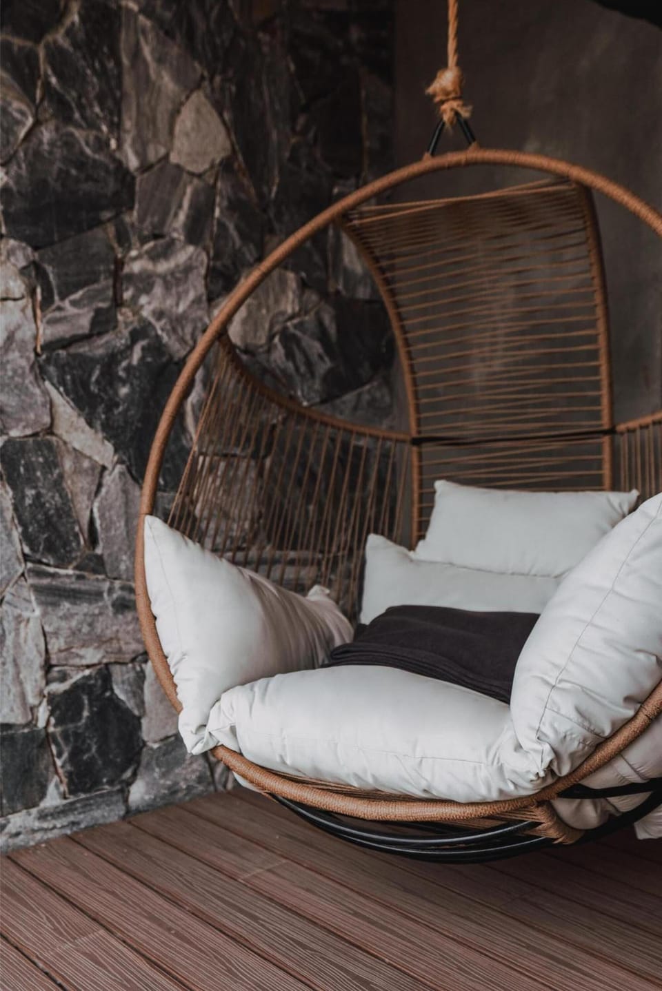 Curl up outdoors in a cushioned swing for sunset lounging.