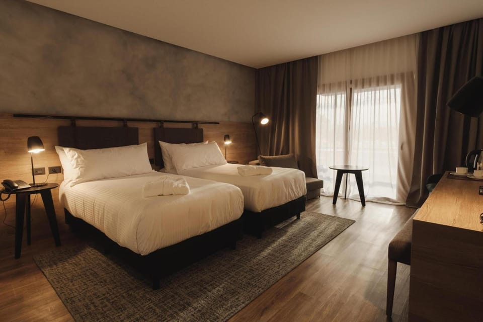 Unwind in plush twin beds with soft, warm lighting.