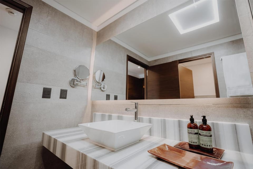 Refresh at a sleek vanity with premium bath amenities.