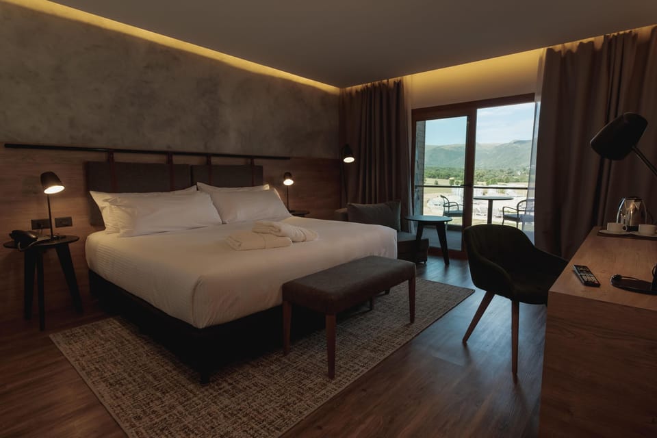 Wake slowly to mountain views framed by soft, cozy drapes.