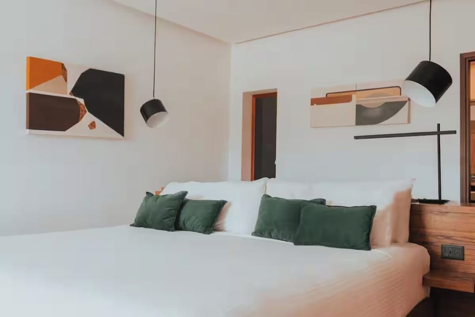 Sink into an inviting king bed with soft, calming accents