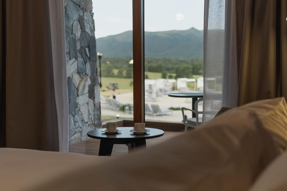 Sip morning coffee by the window, gazing over green hills.